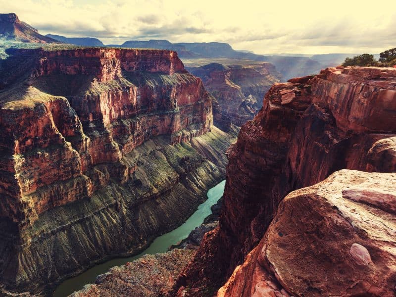 View of the Grand Canyon from above with the Colorado River cutting through it. Final destination on a Denver to Grand Canyon road trip.