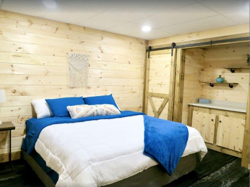 King bedroom with barn doors in Hocking Hills pet-friendly vrbo