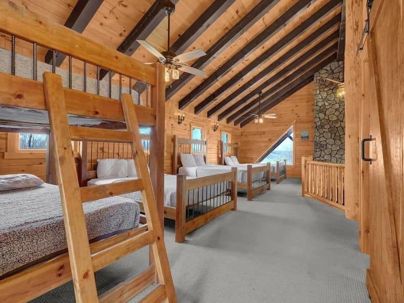 Open loft room with extra beds and bunks in large Hocking Hills cabin rental