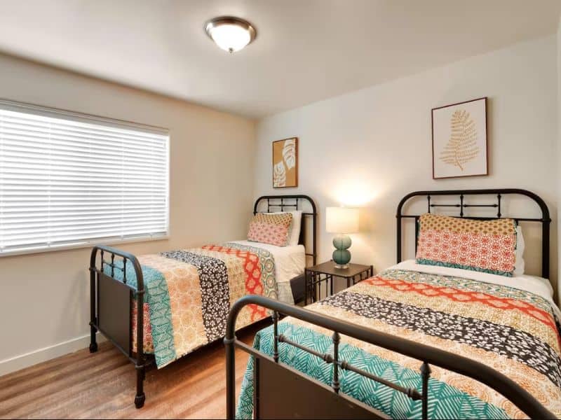 Twin beds with colorful bedding in 3-bedroom airbnb in Moab