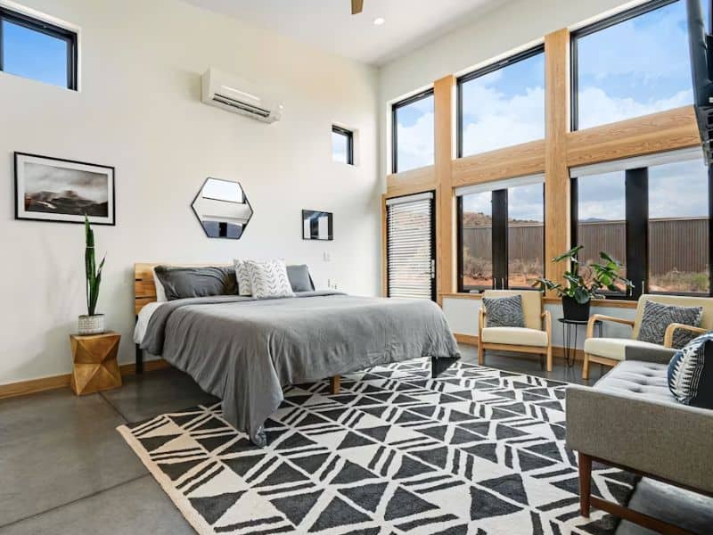 Modern bedroom with large windows at upscale Moab Airbnb - Mt Peale House