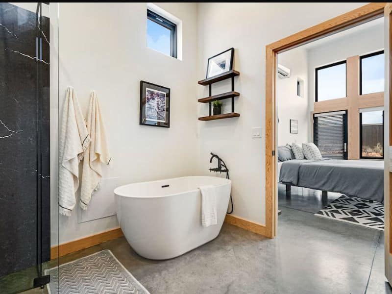 Modern bathroom with standalone bathtub at Mt Peale House luxury vrbo in Moab, UT