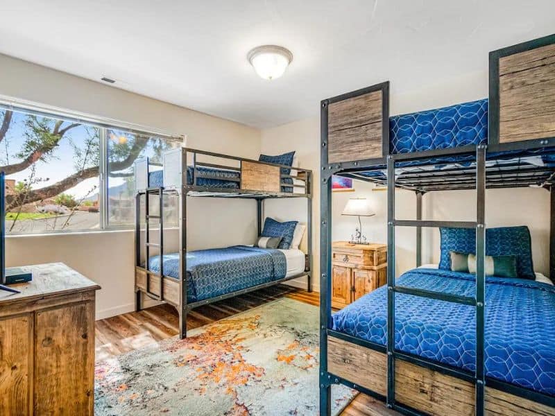 Twin room with 4 bunk beds with blue bedding in well furnished Moab airbnb