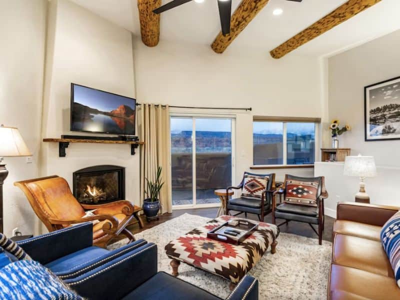 Living room with aztec inspired decor and fireplace at a luxury Moab airbnb in Southgate Village