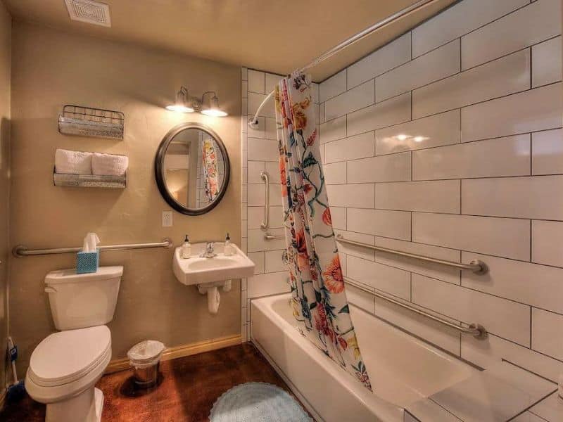 Bathroom with bath shower combo at Wisteria Cottage rental in Moab, Utah