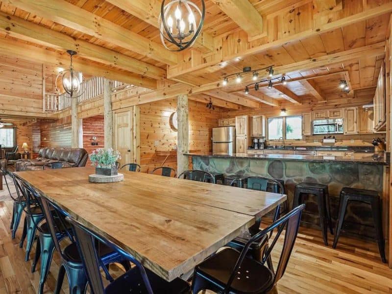 Dining area and kitchen in large rustic wood cabin in Hocking Hills