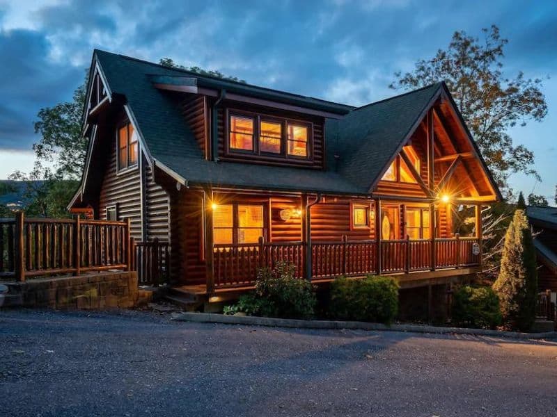 Exterior of log cabin in Pigeon Forge, with classic log design, and wrap around porch.