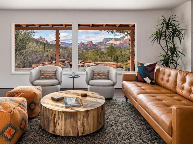 Mid-century modern living area in Sedona home with large windows with red rock views