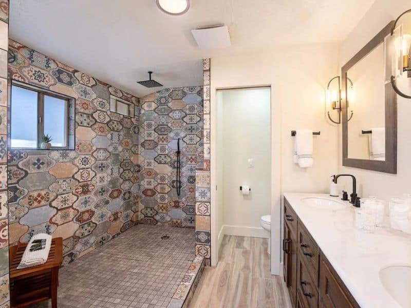 Bathroom with walk in shower with colorful mosaic tiles
