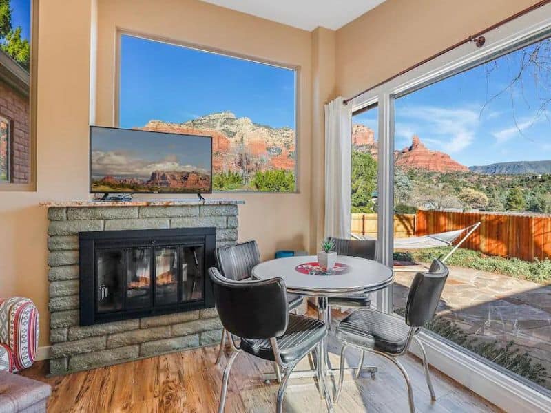Vintage dining nook, with fire place and surrounding views of red rock formations in Sedona rental home.