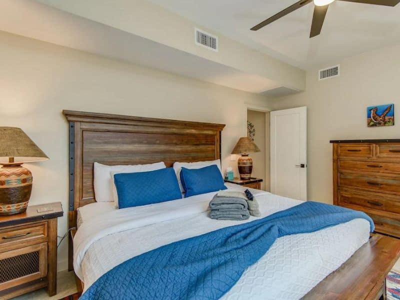 Master bedroom of Sedona rental home with heavy wooden accents.
