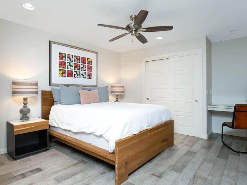Queen bedroom in Sedona vacation rental with artwork and ceiling fan
