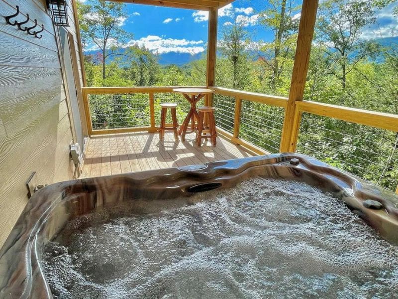 Hot tub on a covered deck overlooking Great Smoky Mountains