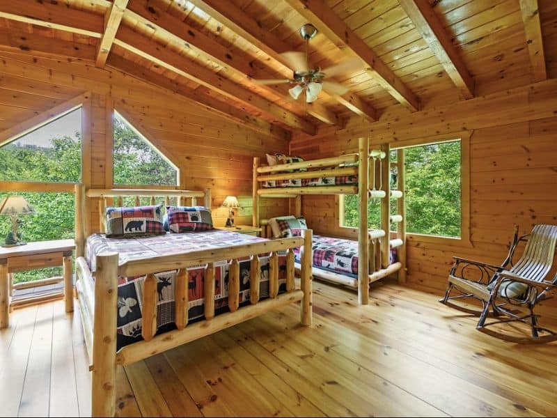Large guest room in Gatlinburg cabin rental with queen bed and twin bunk bed