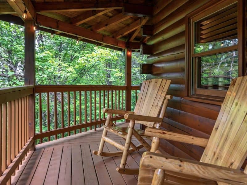 Covered wooden porch with rocking chairs