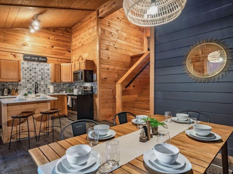 Modern kitchen and dining area with wood accents and designer finishes