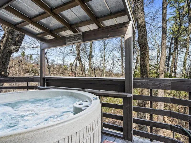 Hot tub on covered deck overlooking trees