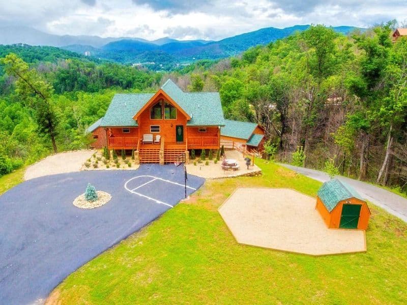 Exterior view of large pet-friendly Gatlinburg cabin with basketball court