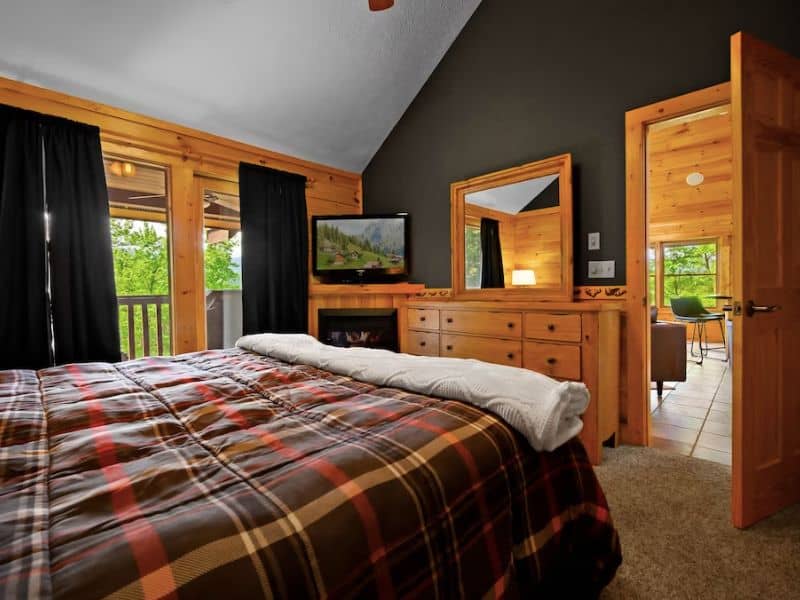 Bedroom in Gatlinburg pet-friendly cabin rental with plaid comforter and TV