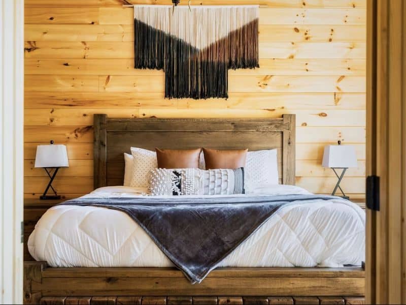 Luxurious king bed in main suite at cabin rental in Gatlinburg TN