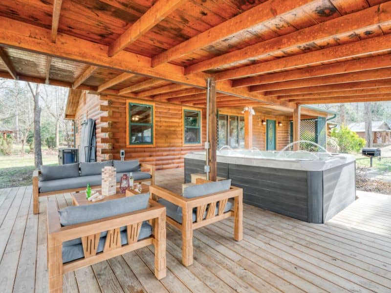 Covered deck with hot tub and outdoor seating