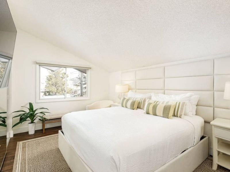 A bedroom in Aspen CO with a white bed and a window.