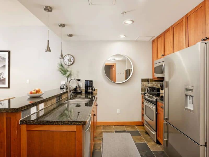 A kitchen with stainless steel appliances and granite counter tops.
