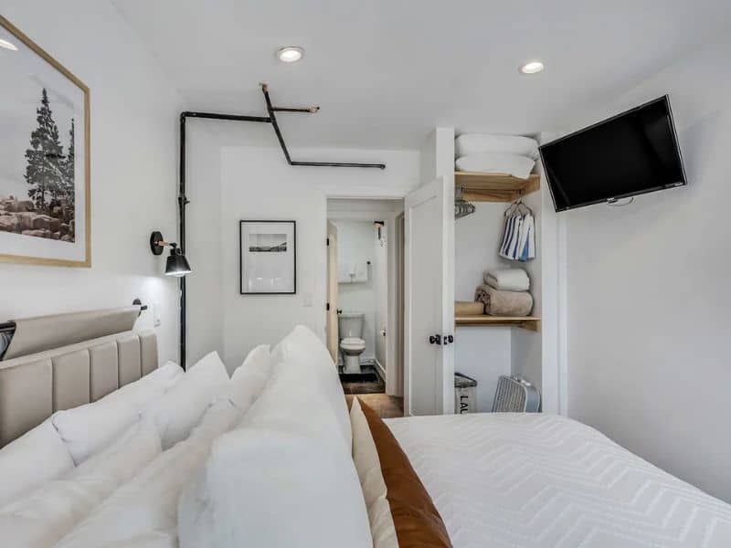 A bedroom with a bed and a tv.