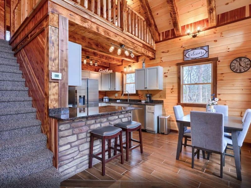 Kitchen and dining area with barstools in one-bedroom luxury cabin in Hocking Hills, OH.