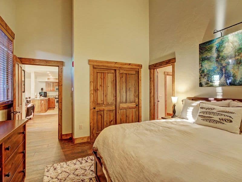 A bedroom in a Breckenridge CO vrbo with a large bed and a painting on the wall.