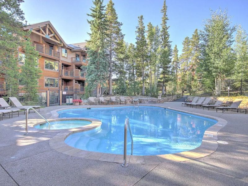 A swimming pool in front of an apartment complex located in Breckenridge CO.