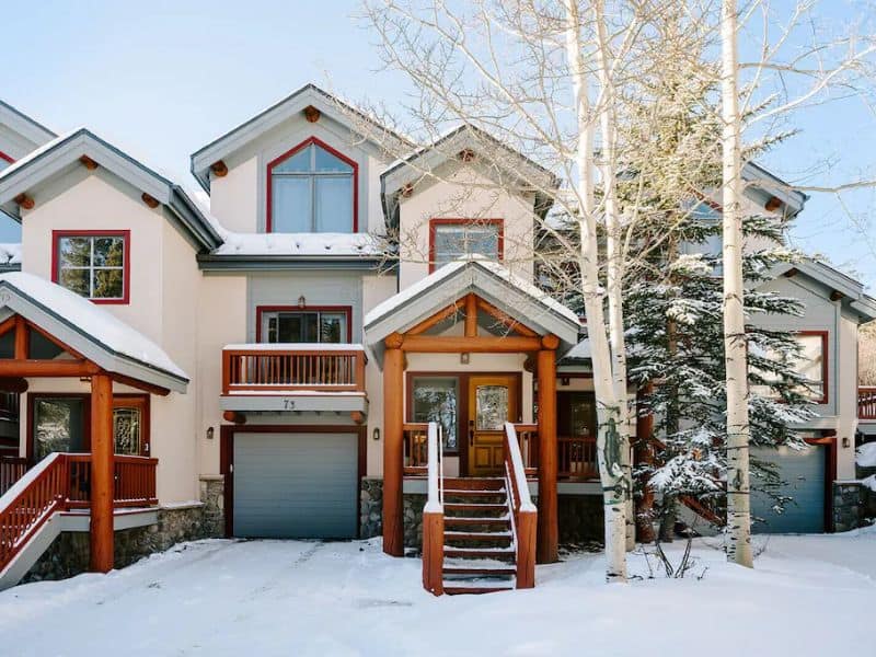 A three story ski in ski out vrbo in Breckenridge CO with snow on the ground.