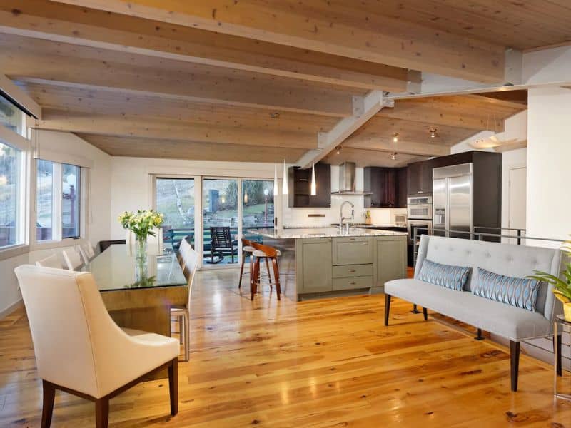 A kitchen and dining room with wooden floors in an Aspen vacation rental.