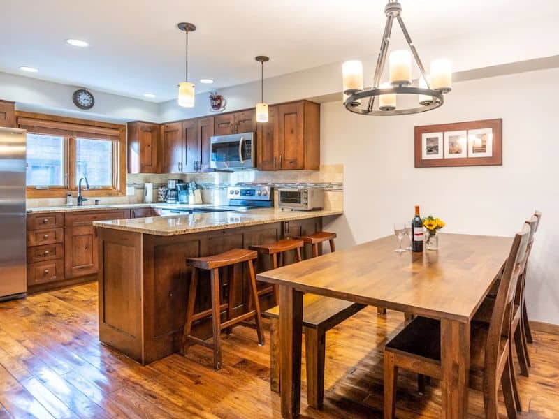 An updated kitchen with wood floors and a table and chairs at a townhome rental in Breckenridge CO.