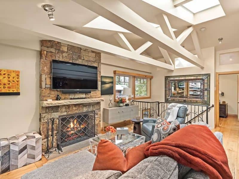 A living room in Aspen, CO featuring a fireplace and vaulted ceiling.