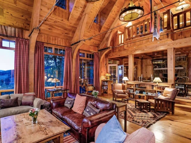 A spacious living room with wood finishes in a Wildcat Ranch estate 5 minute from Snowmass skiing in Aspen CO.