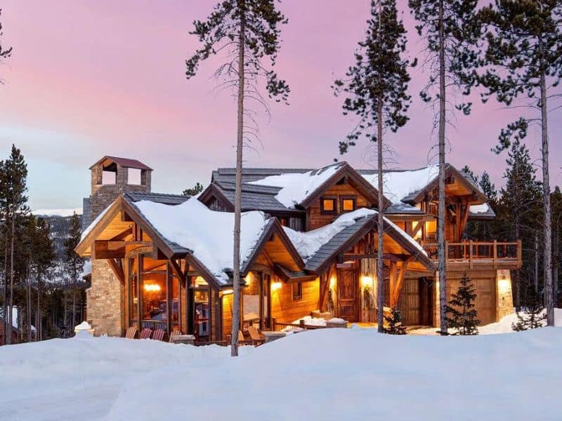 A large ski in ski out cabin rental on a snowy hillside in Breckenridge CO.