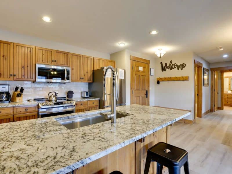 An updated kitchen with granite counter tops and stainless steel appliances.