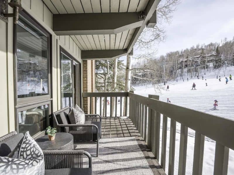 A balcony overlooking a ski slope at a true. ski in ski out rental in Aspen CO reservable on Vrbo.