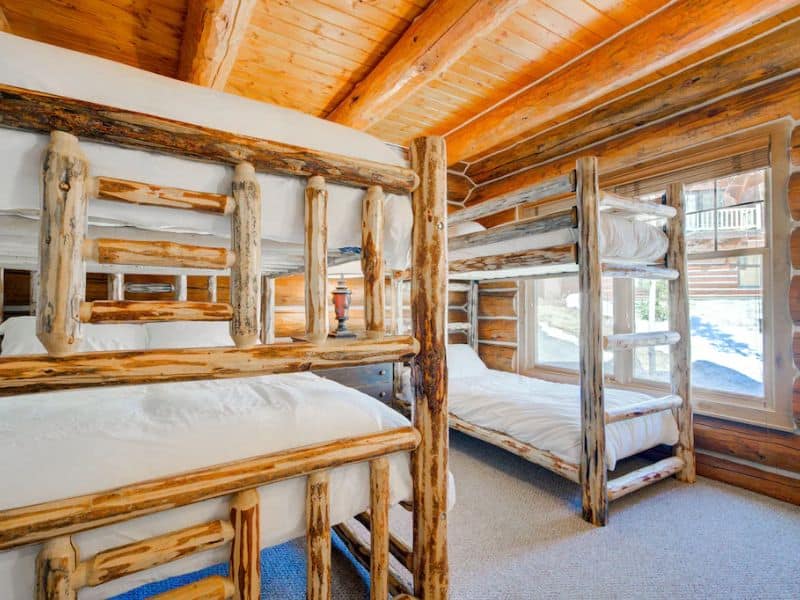 Rustic bunk room with handcrafted beds in a ski in ski out rental in Big Sky, MT.