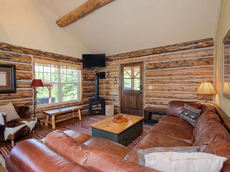 A cozy living room in a ski in ski out log cabin rental in Big Sky Montana.