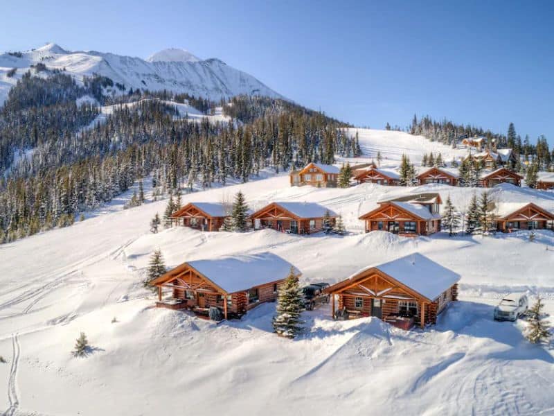 Big Sky MT ski in ski out rental cabins on top of a snowy mountain.