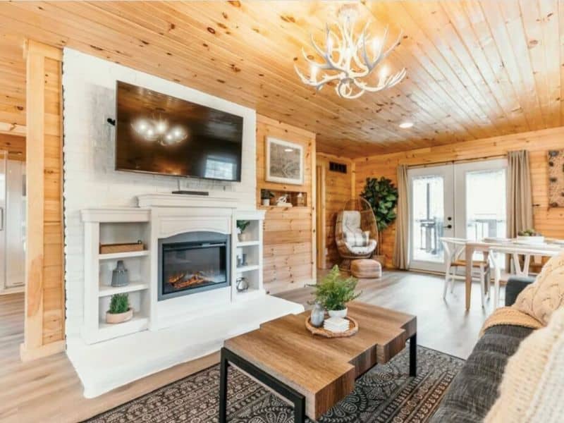 Cozy living room with a modern electric fireplace and comfortable seating in a Hocking Hills rental cabin.