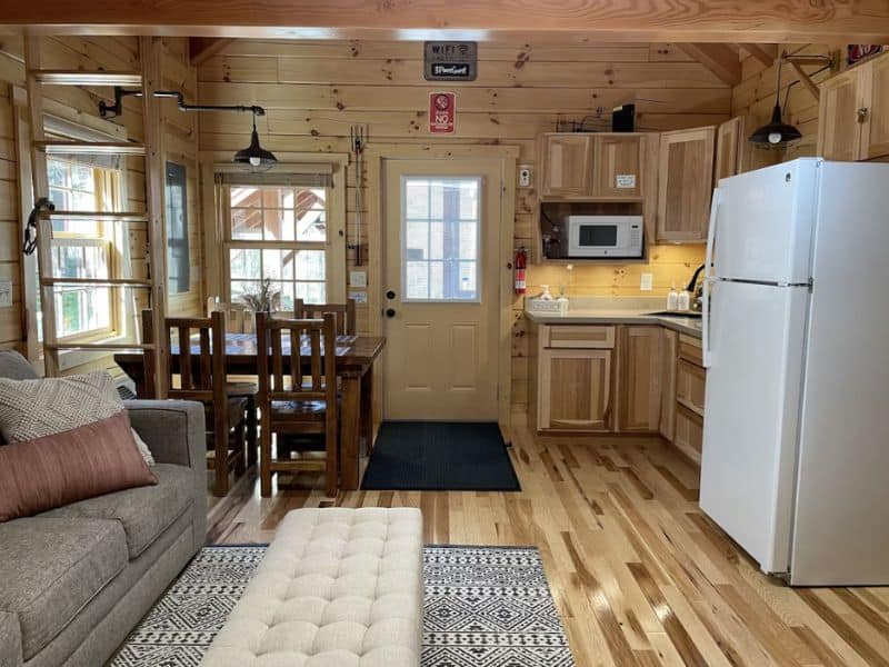 Inside of a small cabin rental for 2 in Hocking Hills with dining table and kitchenette.