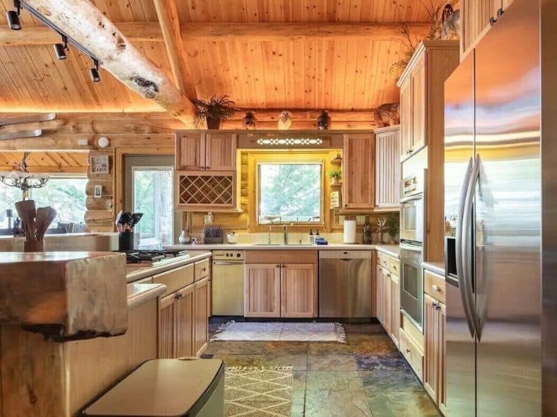 Bright kitchen with natural wood cabinets and modern appliances in a Big Bear cabin, showcasing a cozy mountain retreat feel.