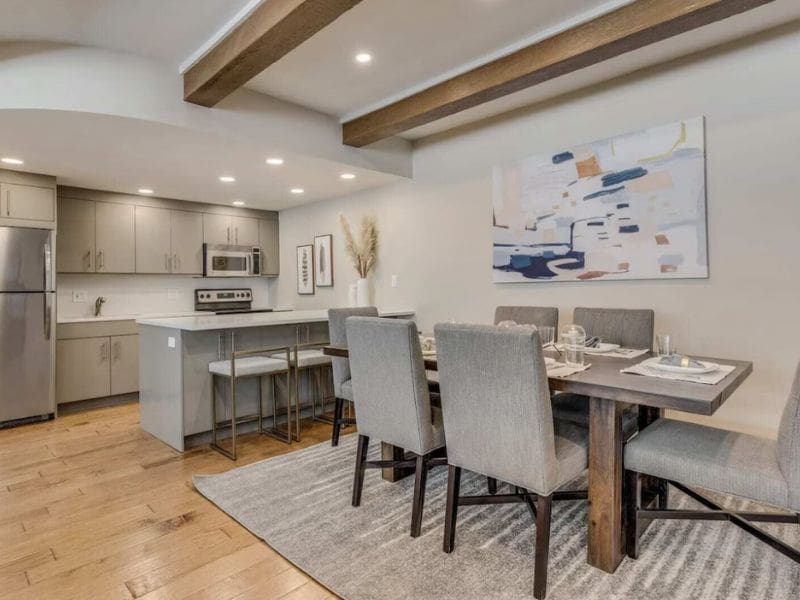 A modern apartment in Aspen CO with a kitchen and dining area.