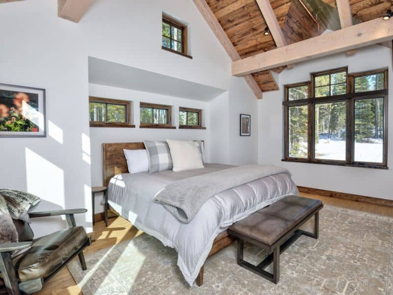 A bedroom with wood beams and a bed in Big Sky, MT.