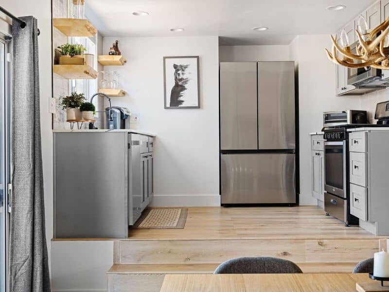Modern kitchen with stainless steel appliances and open shelving, a stylish feature in a Big Bear winter cabin rental near Snow Summit.