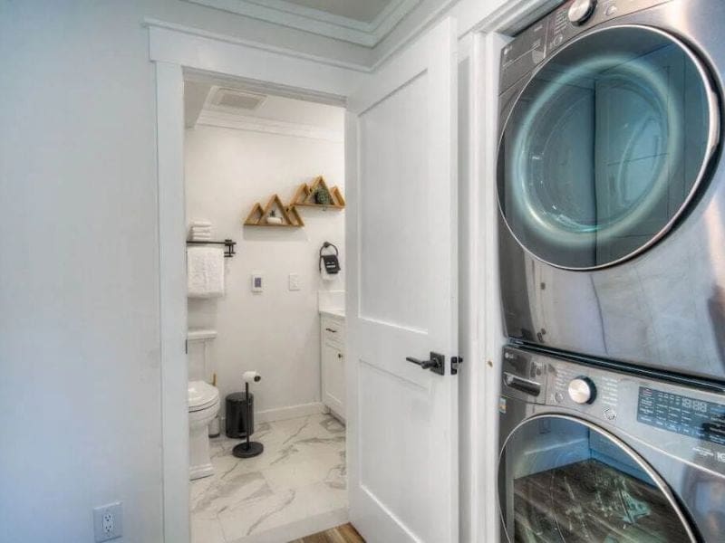 Big Sky Vrbo rental with a laundry room equipped with a washer and dryer leading into a bathroom.