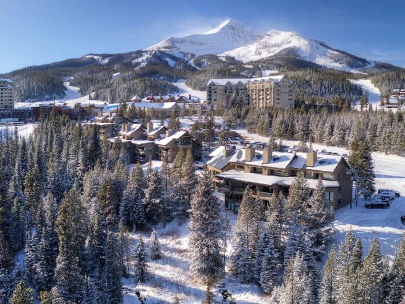 An aerial view of Big Sky MT ski resort with snow covered mountains.